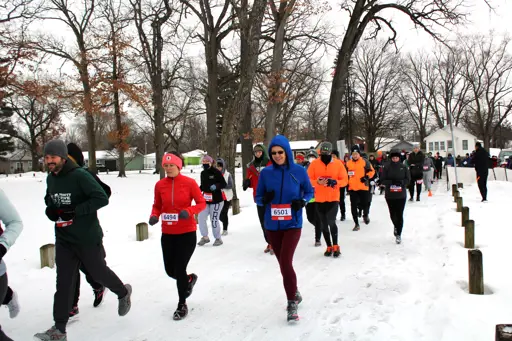 Runners participating in the Frosty Five Run with snow on the ground