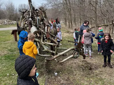 Kids at Recyclesaurus Rex statue at EEC
