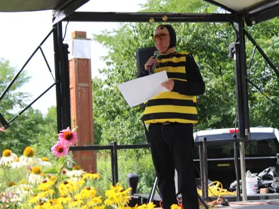 Announcer dressed as bumblebee at Pollinator Promenade event