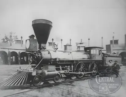 Photo of the Robin (the first locomotive to enter Elkhart) at the Elkhart engine house in 1867 with engineer Tom Boyd (holding oil can) and fireman A.M. “Gus” Bickel and W.H. Hall in the cab. 