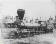 Photo of the Robin (the first locomotive to enter Elkhart) at the Elkhart engine house in 1867 with engineer Tom Boyd (holding oil can) and fireman A.M. “Gus” Bickel and W.H. Hall in the cab. 