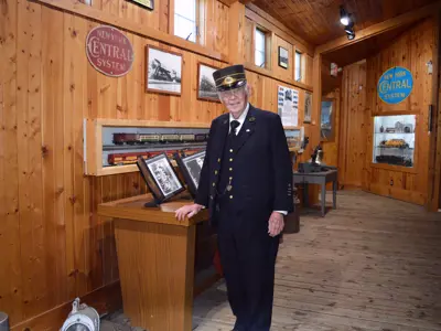Photo of the NNYCRRM freight deck hallway with a man dressed as a train conductor. 