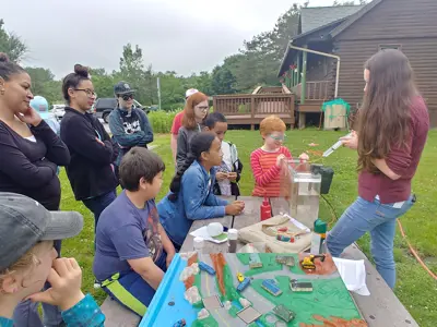 EEC staff teaching kids with EnviroScape and Groundwater Model