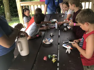 Kids making bugs out of egg cartons