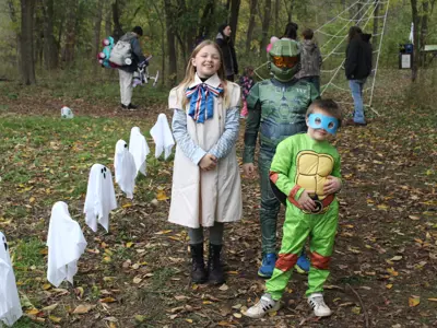Kids in costume on trail at Haunted Walk event