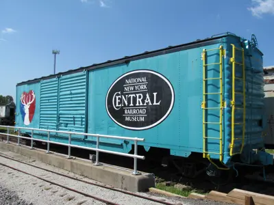 Photo of the NNYCRR Museum's teal boxcar with the logos of the City of Elkhart and the Museum painted on it. 