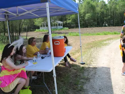 Volunteers judging costume contest at Pollinator Promenade event at EEC