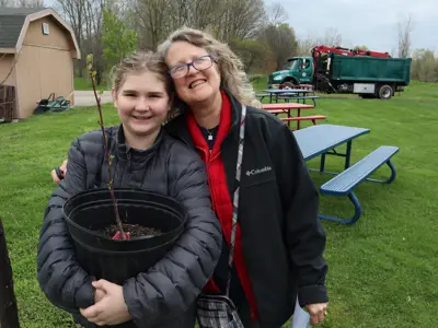 Family with free tree at Earth Day event