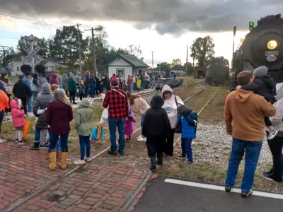 A line of visitors waiting to ride the NIBCO Century Flyer at the NNYCRRM for the museum's Spooktacular Express nighttime rides