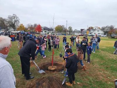 Elkhart Mayor Rod and community members planting tree at Roosevelt Park