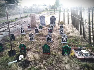 Halloween decorations made to look like an old cemetery alongside the tracks of the NIBCO Century Flyer amusement train for the NNYCRRM's Spooktacular Express event