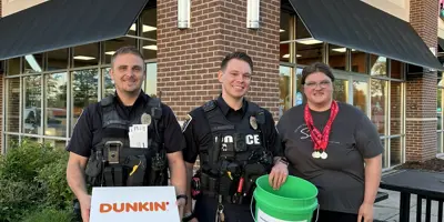 Officers and Athlete at Cop on a Rooftop Special Olympics Fundraiser 2025