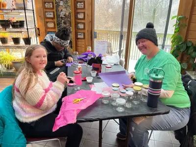 Family making crafts at Eco-Valentine's Day program at EEC