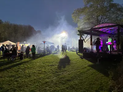 Food vendors and music stage at night at Haunted Walk event