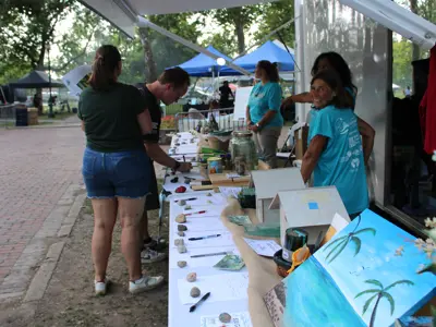 Volunteers helping at silent auction at EnviroFest event