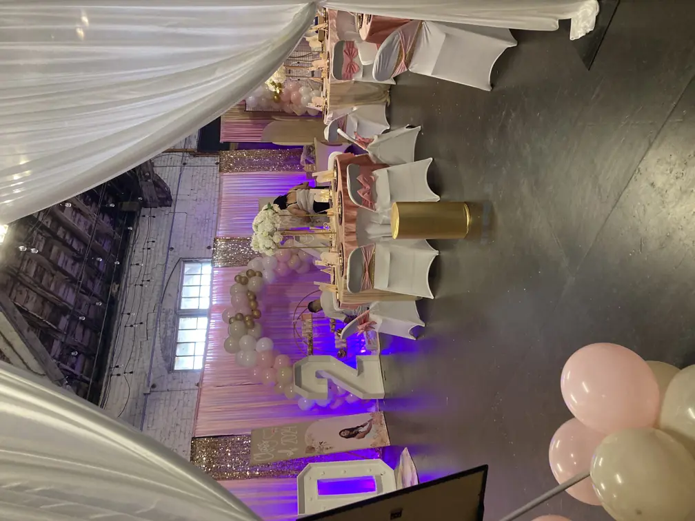 The museum event space decorated for a graduation party with balloons and colorful lights