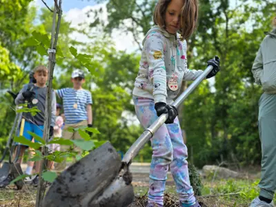 Kid planting tree at Junior Indiana Master Naturalist program at EEC