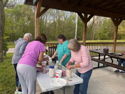 Participants choosing supplies for Hummingbird Yard Art program at EEC