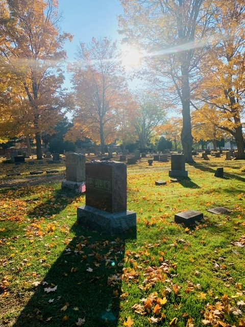 Headstones and autumn trees covered in golden leaves in Prairie Street cemetery