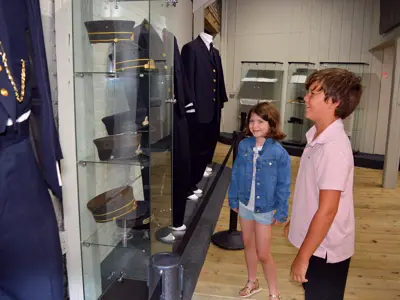 Two children look at New York Central Uniforms at the NNYCRRM