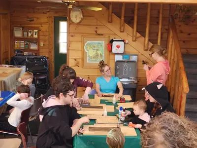 Group making bat house at program at EEC